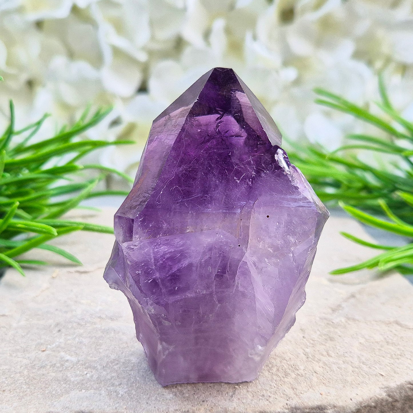 Brazilian Amethyst standing point with natural sides and polished tip. A popular calming crystal for stress relief and quiet reflection spaces.