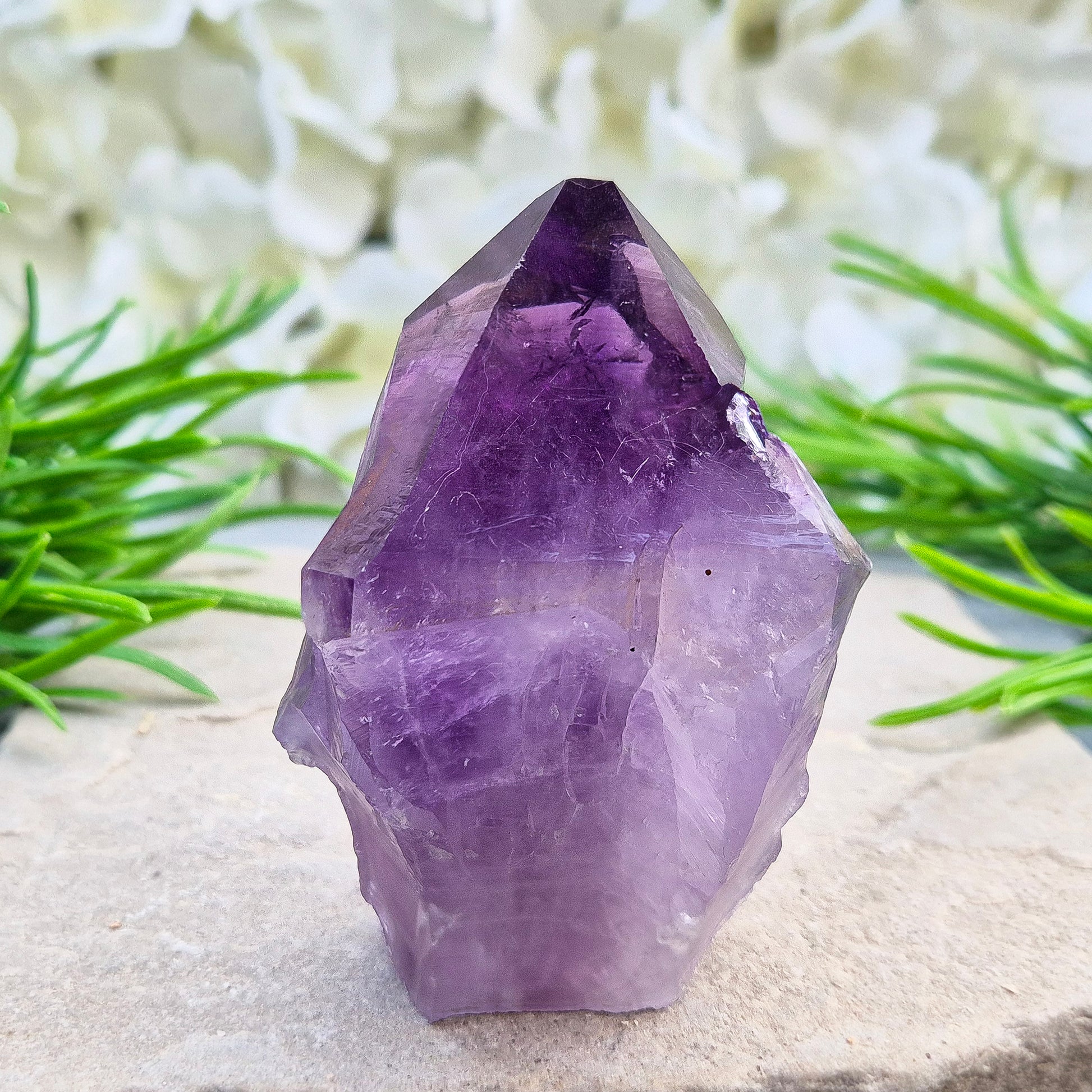 Brazilian Amethyst standing point with natural sides and polished tip. A popular calming crystal for stress relief and quiet reflection spaces.
