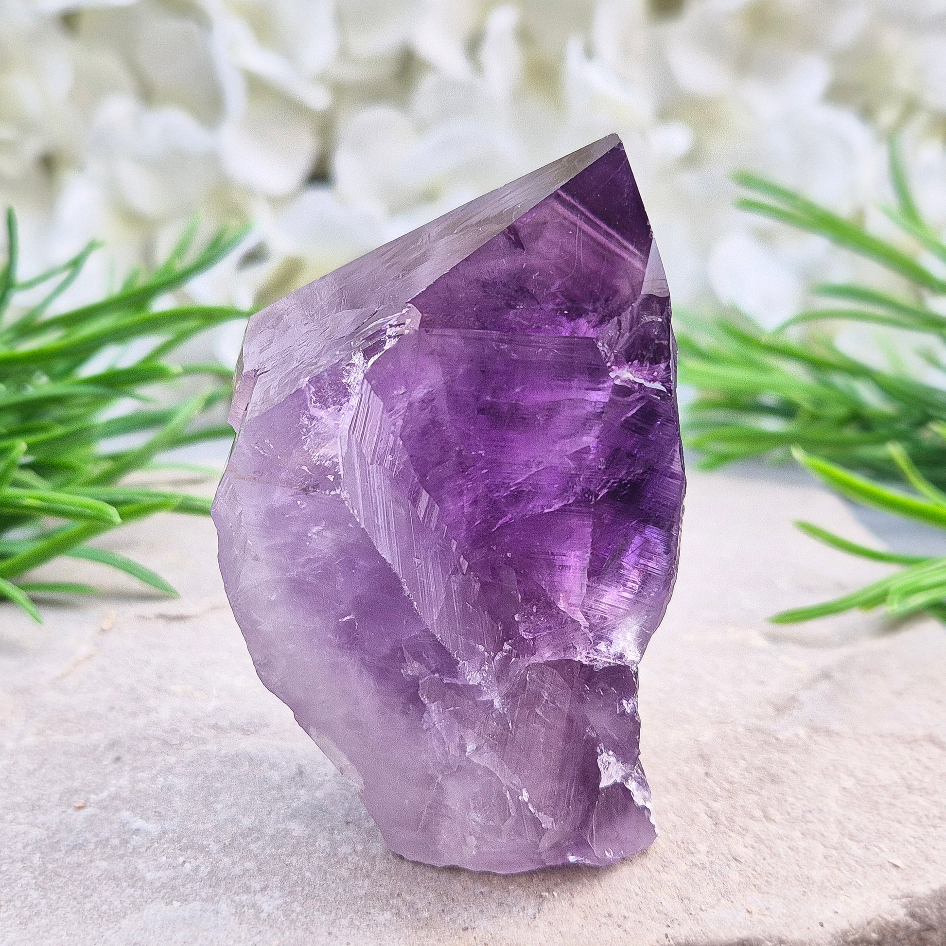 Brazilian Amethyst standing point with natural sides and polished tip. A popular calming crystal for stress relief and quiet reflection spaces.