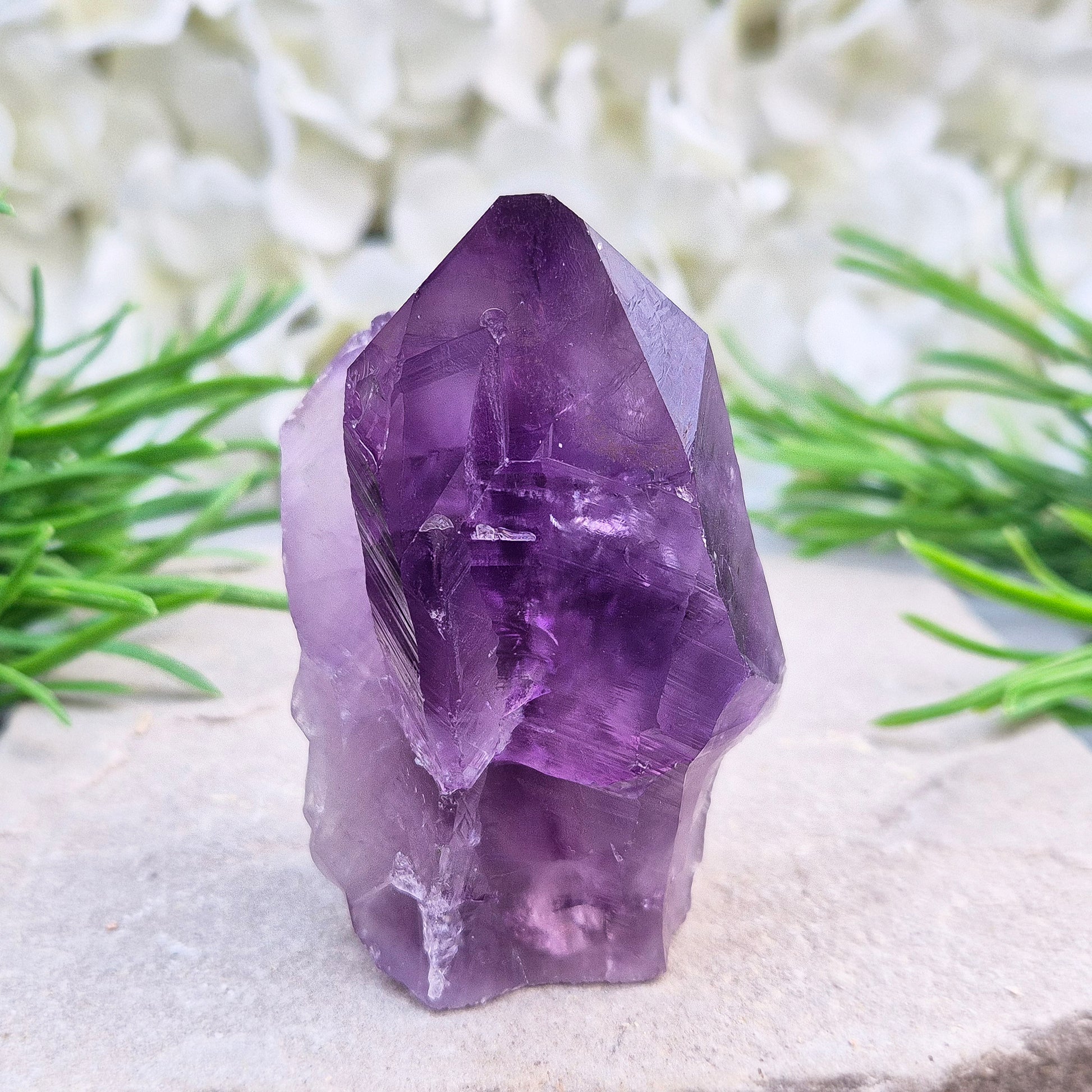 Brazilian Amethyst standing point with natural sides and polished tip. A popular calming crystal for stress relief and quiet reflection spaces.