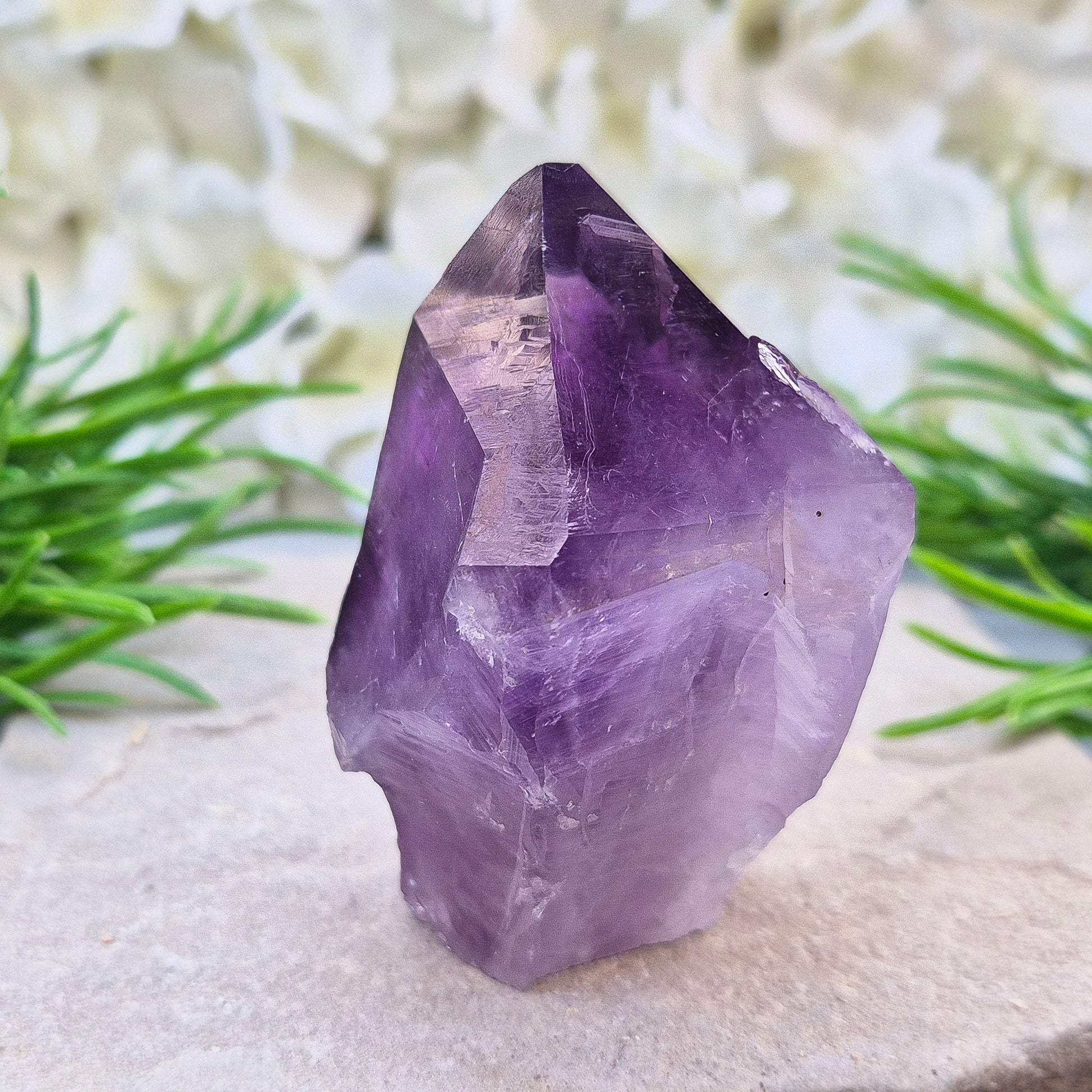 Brazilian Amethyst standing point with natural sides and polished tip. A popular calming crystal for stress relief and quiet reflection spaces.
