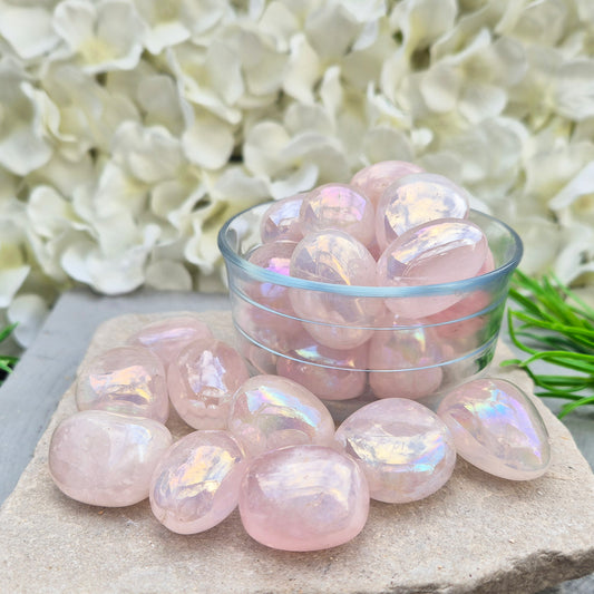 Rose Quartz Aura tumblestones, polished pink crystals with iridescent sheen. Heart chakra stones for emotional support and meaningful crystal gifts.