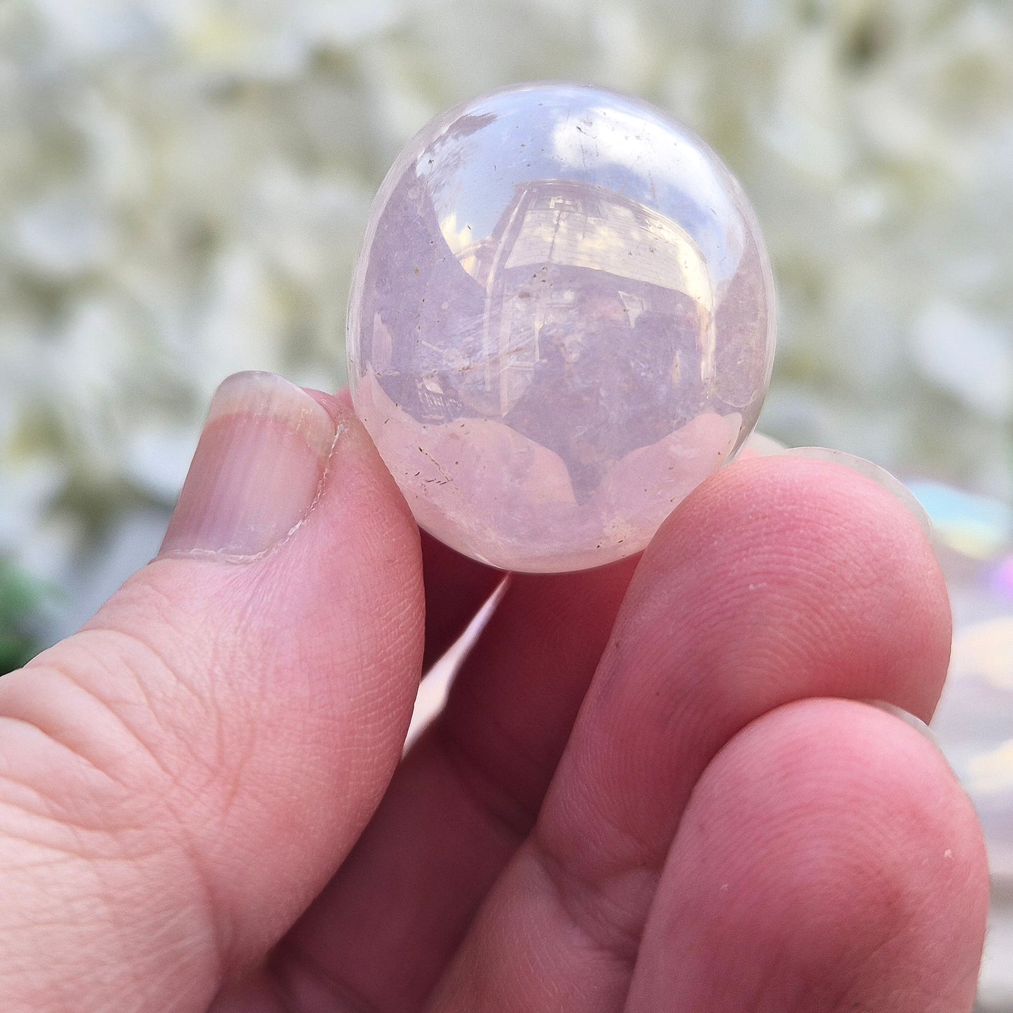 Rose Quartz Aura tumblestone, polished pink crystals with iridescent sheen. Heart chakra stones for emotional support and meaningful crystal gifts.