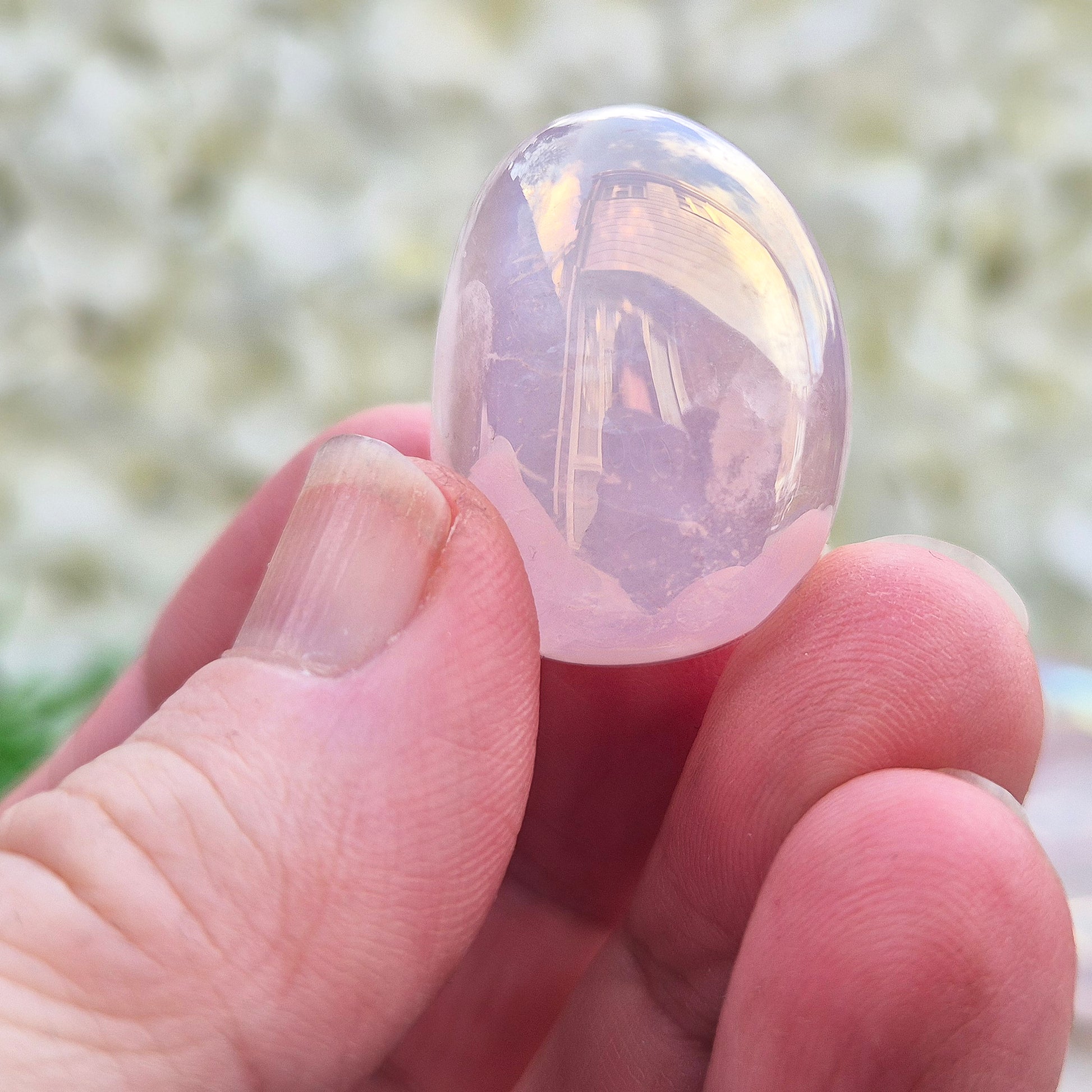 Rose Quartz Aura tumblestone, polished pink crystals with iridescent sheen. Heart chakra stones for emotional support and meaningful crystal gifts.