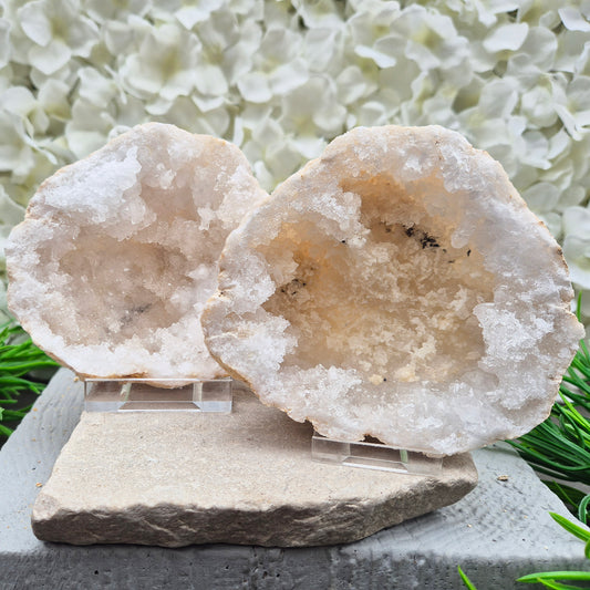 Decorative Quartz crystal geode pair with bright white points and natural cave formation. Ideal for meditation spaces, home décor, and crystal collections.