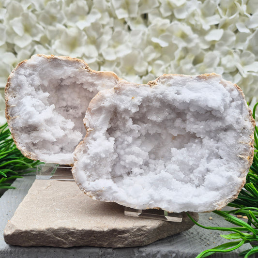 Sparkling Quartz geode pair with mirrored halves and acrylic stands. A beautiful crystal formation for creating a peaceful atmosphere and uplifting the energy of any room.