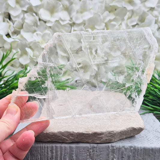 Gypsum crystal transparent window plate from Mexico, used for cleansing and charging crystals or jewellery. Includes clear acrylic stand.