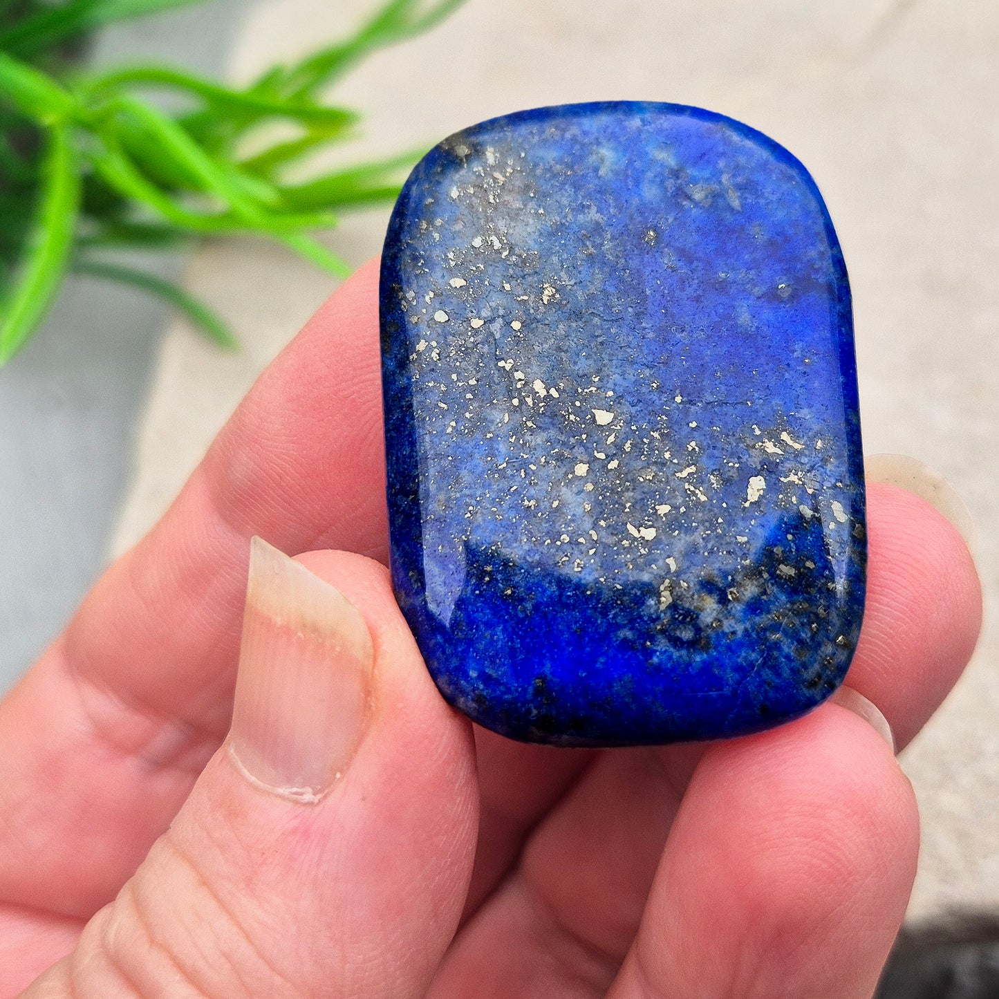 Rectangle Lapis Lazuli palm stone with deep royal blue colour and natural gold flecks. A calming crystal for confidence, communication, and thoughtful reflection.