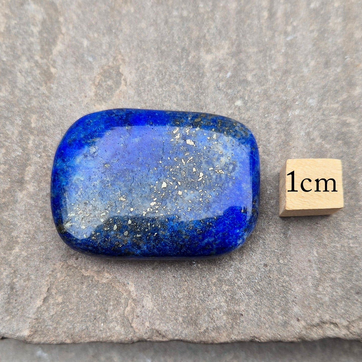 Rectangle Lapis Lazuli palm stone with deep royal blue colour and natural gold flecks. A calming crystal for confidence, communication, and thoughtful reflection.