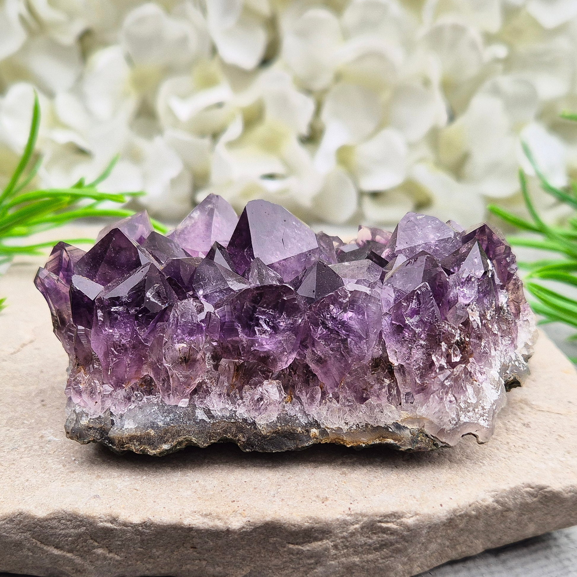 A grade Brazilian Amethyst cluster with deep purple points. A calming crystal for peaceful home spaces, bedrooms, and thoughtful crystal gifts.