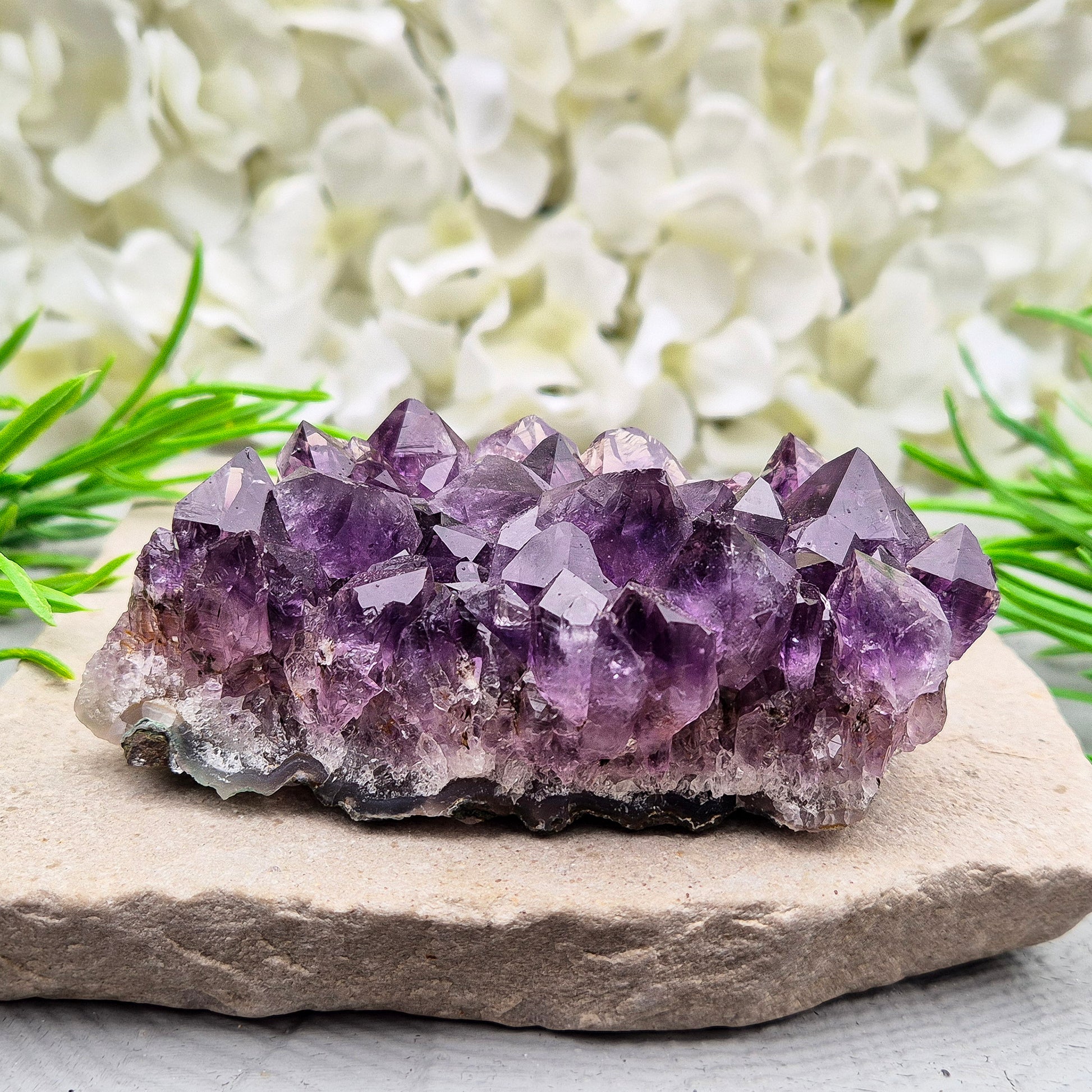 A grade Brazilian Amethyst cluster with deep purple points. A calming crystal for peaceful home spaces, bedrooms, and thoughtful crystal gifts.