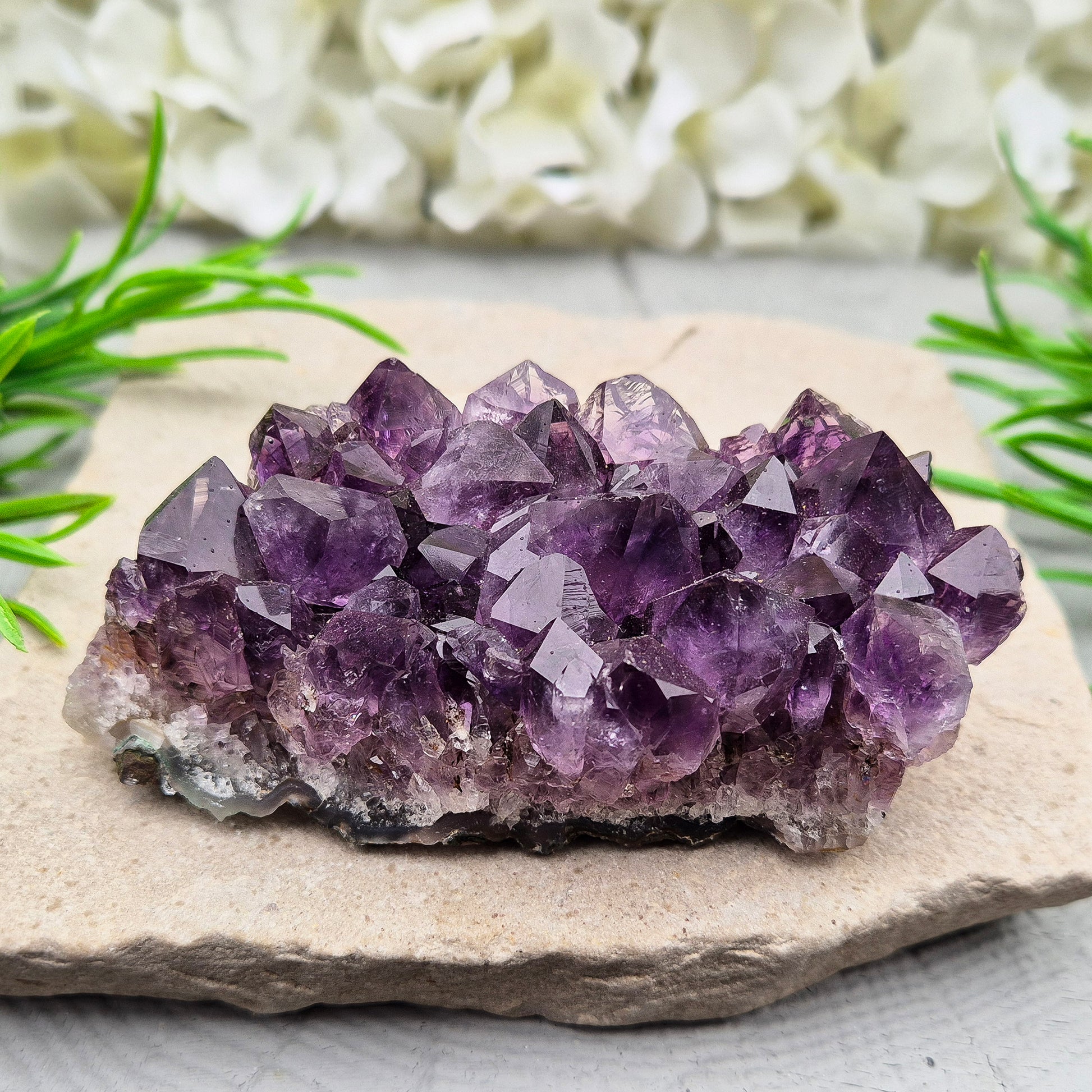 A grade Brazilian Amethyst cluster with deep purple points. A calming crystal for peaceful home spaces, bedrooms, and thoughtful crystal gifts.