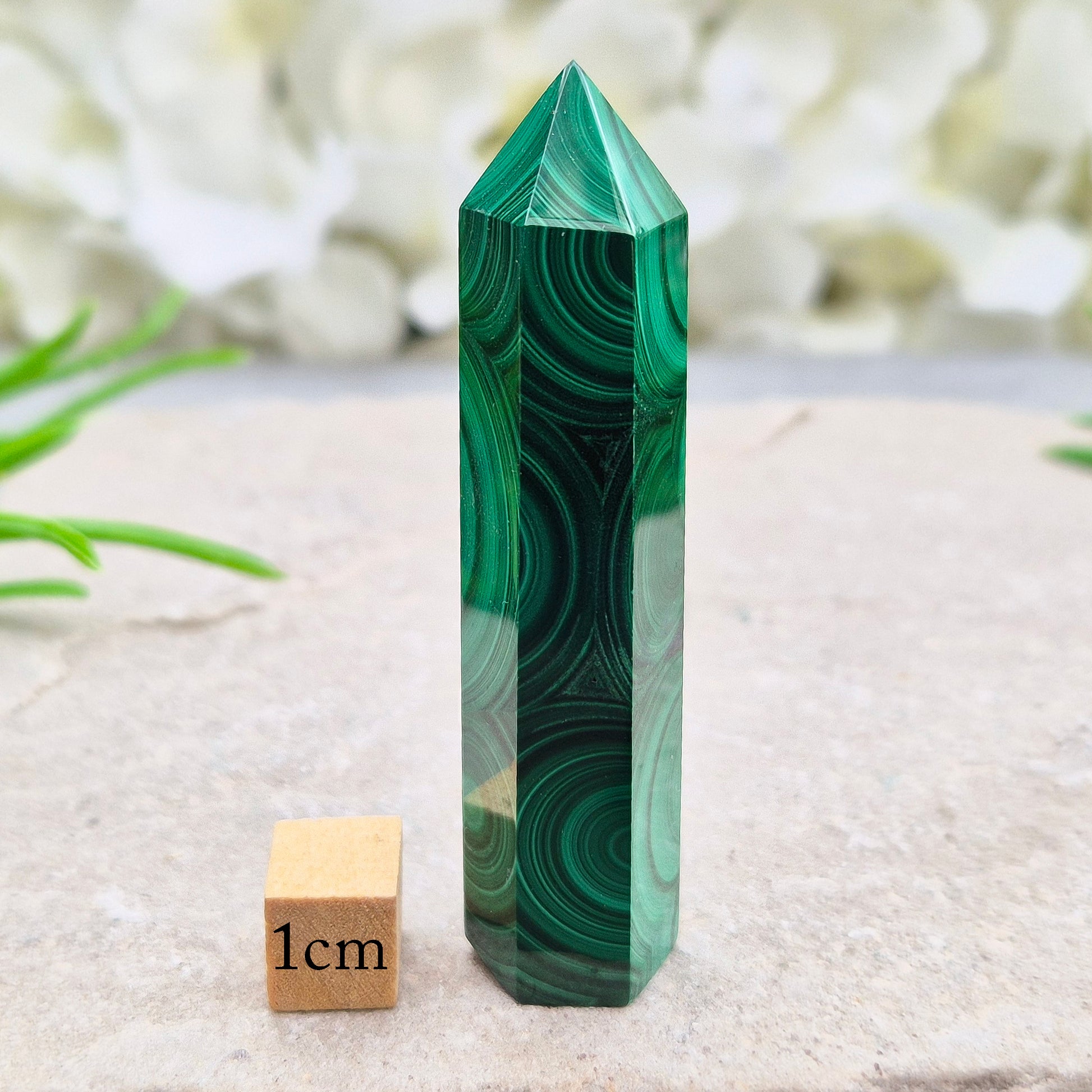 Malachite crystal tower from Congo with vivid green banding. Known as a powerful protection stone for transformation, courage, and personal growth.