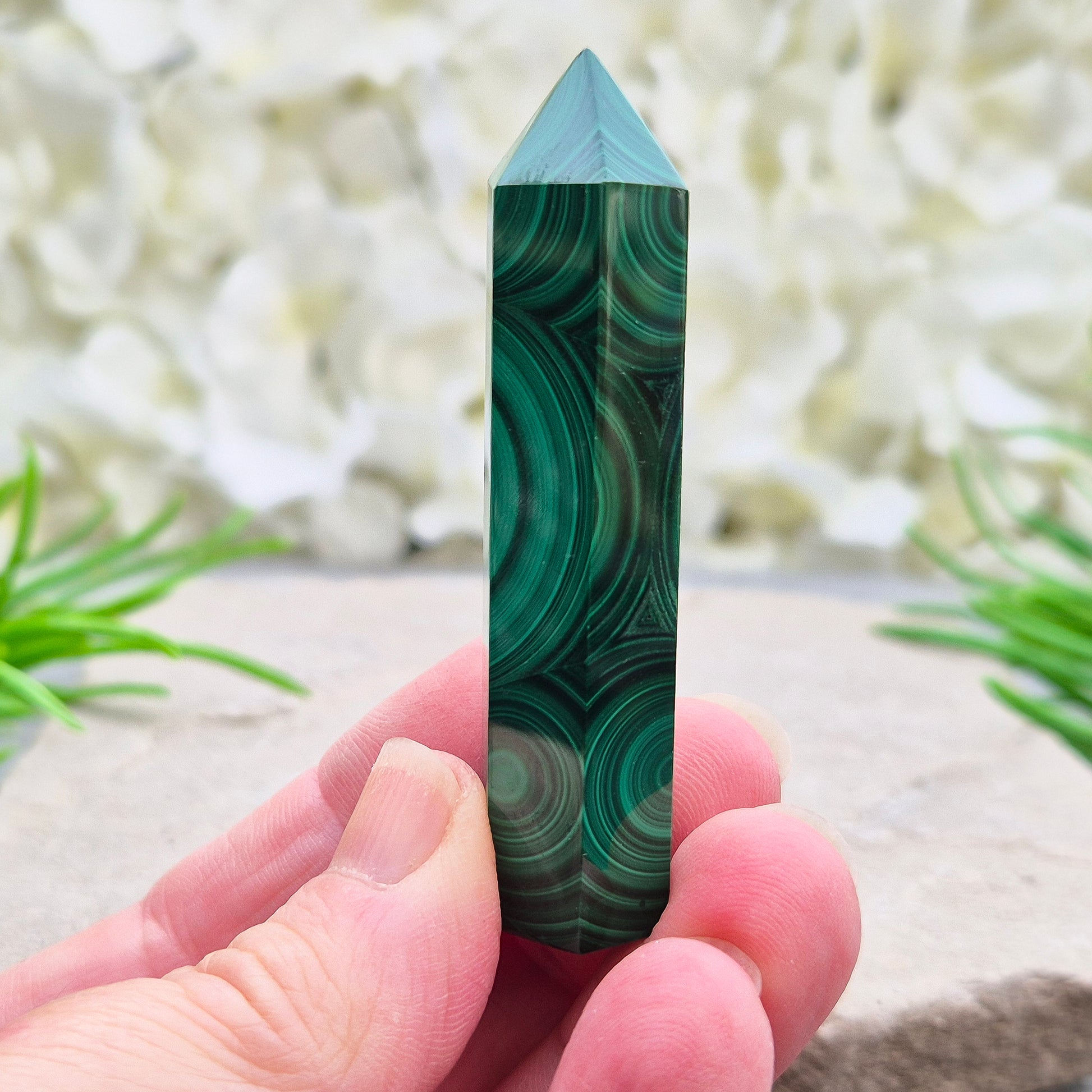 Malachite crystal tower from Congo with vivid green banding. Known as a powerful protection stone for transformation, courage, and personal growth.