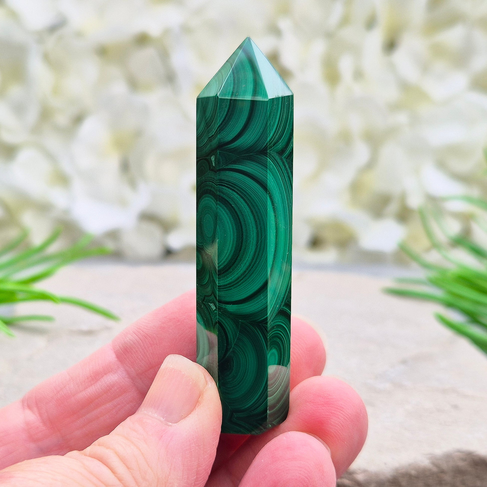 Malachite crystal tower from Congo with vivid green banding. Known as a powerful protection stone for transformation, courage, and personal growth.