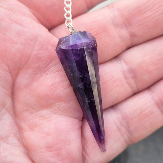 Dark Amethyst crystal pendulum for dowsing and spiritual guidance. A striking divination tool chosen for intuition, pendulum readings, and energy balancing.