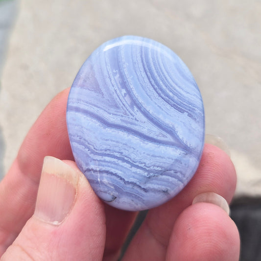 Smooth Blue Lace Agate palm stone for calm, soothing energy and stress relief. Ideal for meditation, healing practices, or carrying with you.