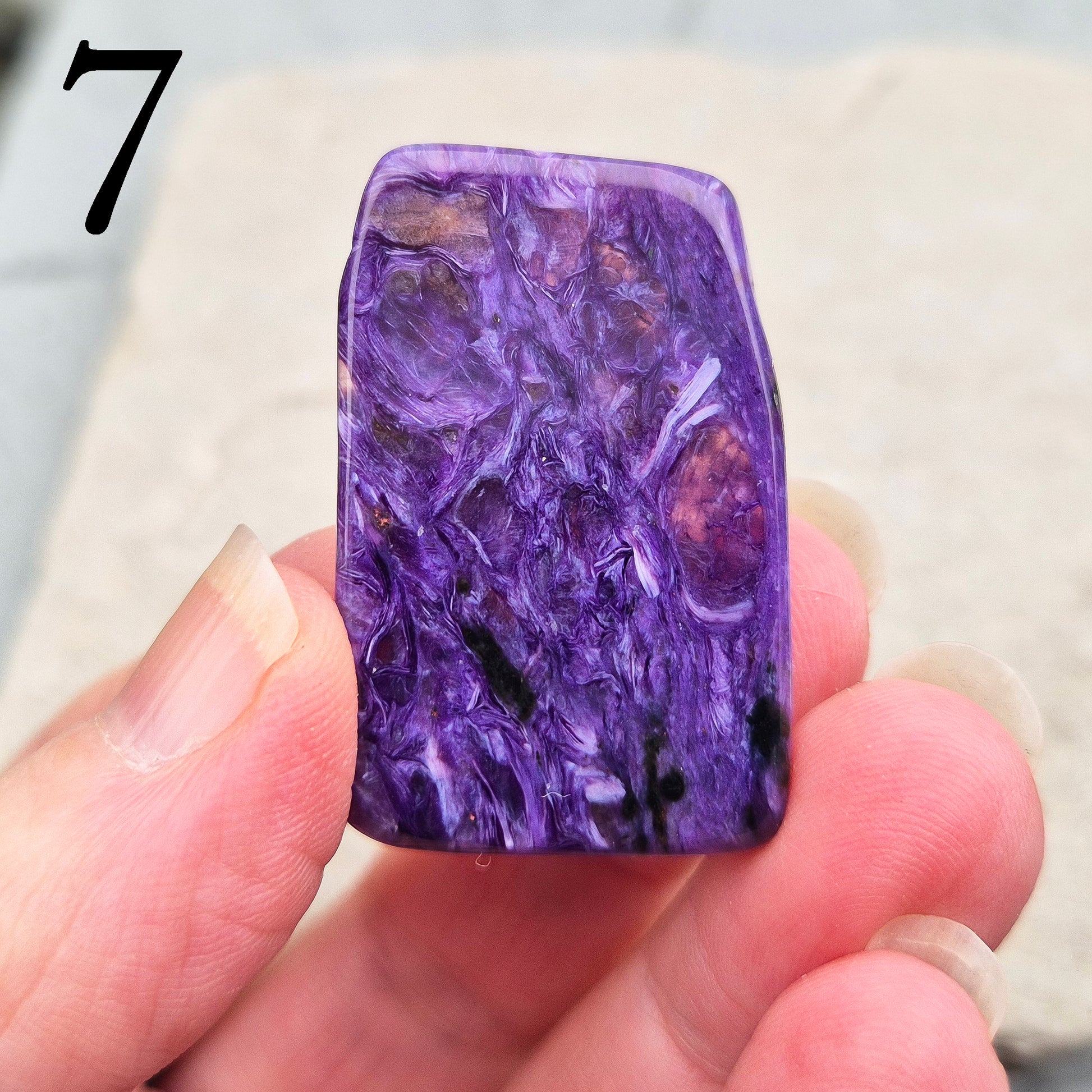 Polished Charoite slice with rich purple swirling patterns. A striking crystal associated with transformation, emotional strength, and personal growth.