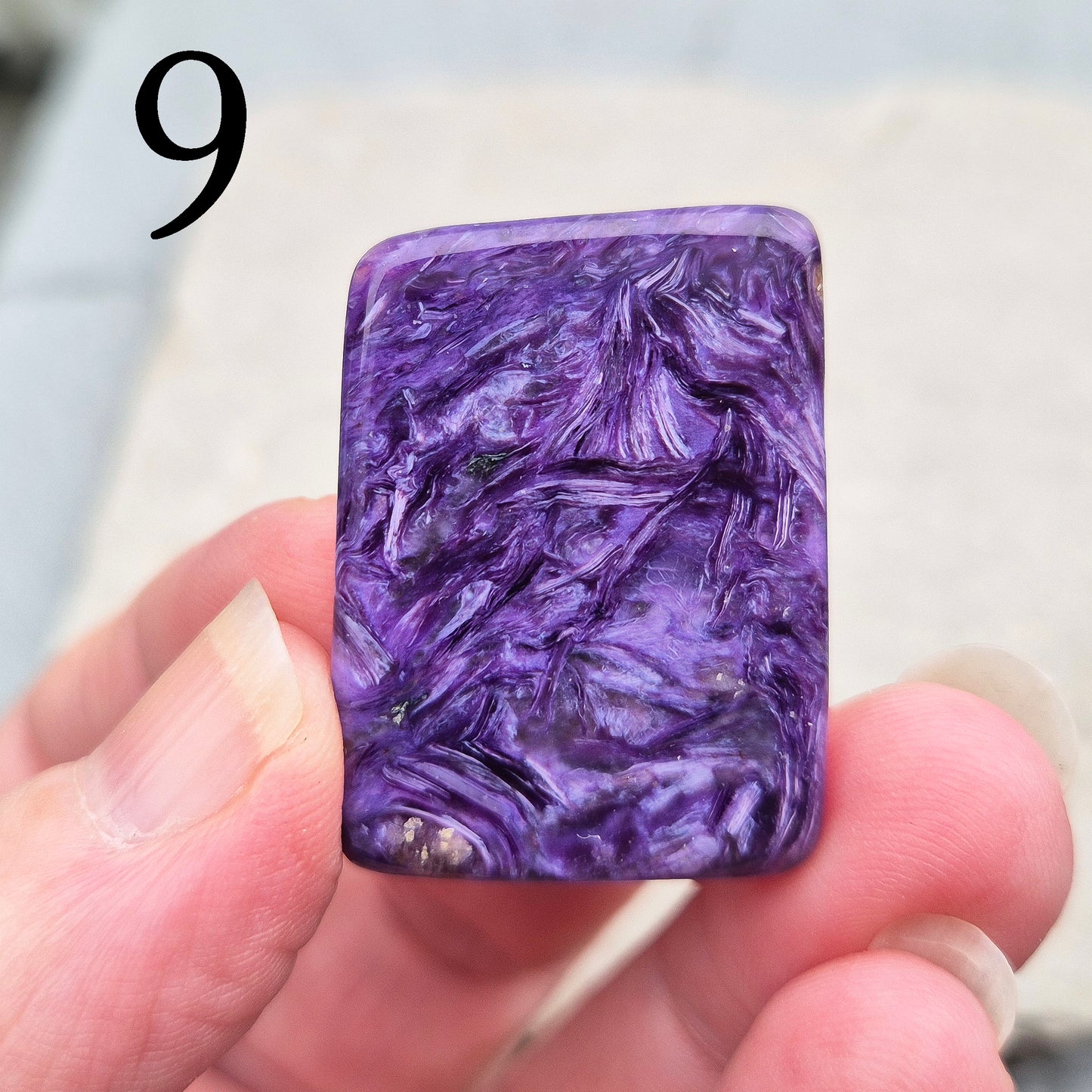 Polished Charoite slice with rich purple swirling patterns. A striking crystal associated with transformation, emotional strength, and personal growth.