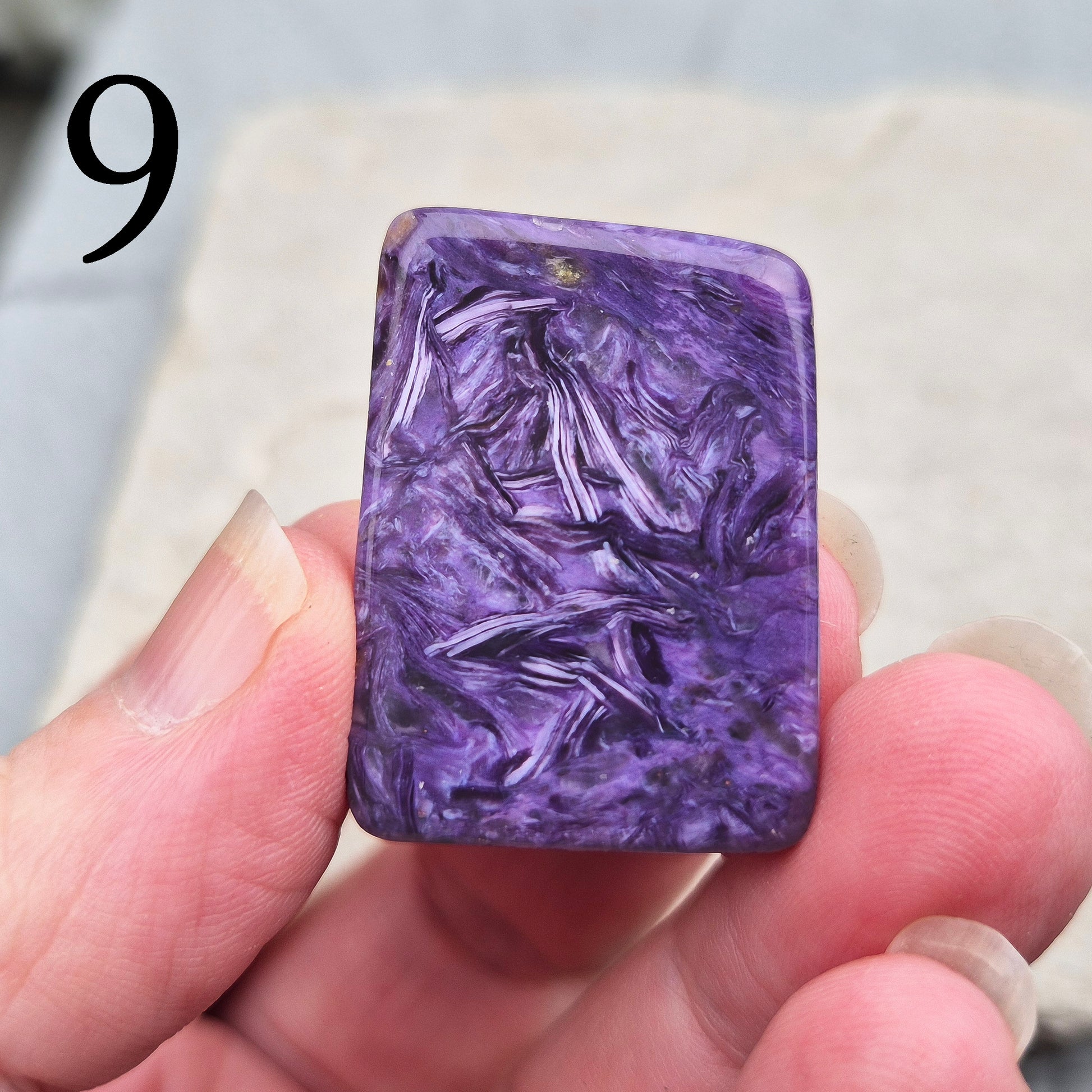 Polished Charoite slice with rich purple swirling patterns. A striking crystal associated with transformation, emotional strength, and personal growth.