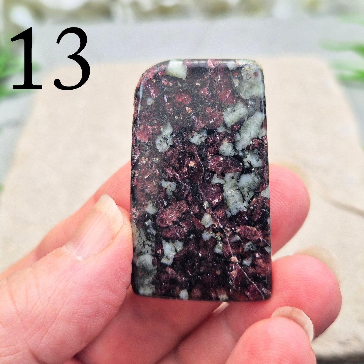 Polished Eudialyte flat stone from Greenland with rich red and pink tones. Associated with emotional steadiness, heart support, and grounded change.