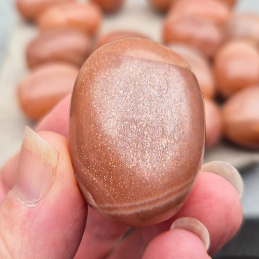 Golden Feldspar XL tumble stone with warm golden colour and natural sparkle. A crystal associated with optimism, creativity, and personal confidence.