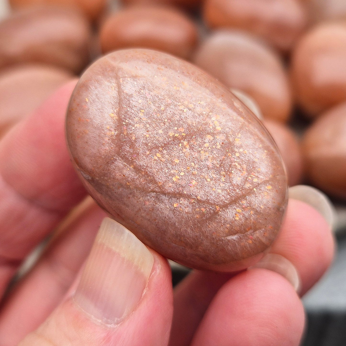 Golden Feldspar XL tumble stone with warm golden colour and natural sparkle. A crystal associated with optimism, creativity, and personal confidence.