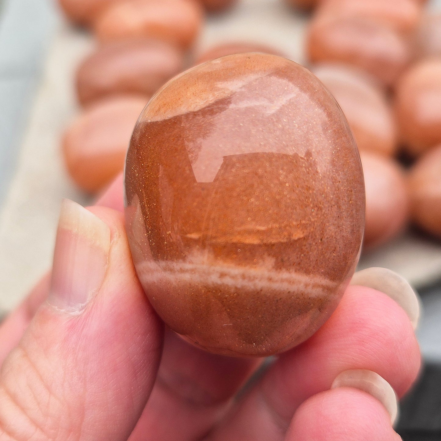 Golden Feldspar XL tumble stone with warm golden colour and natural sparkle. A crystal associated with optimism, creativity, and personal confidence.