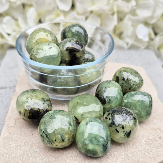 Prehnite with Epidote XL tumblestone from Mali. Natural green crystal with dark inclusions, supporting balance, growth, and steady, grounded energy.