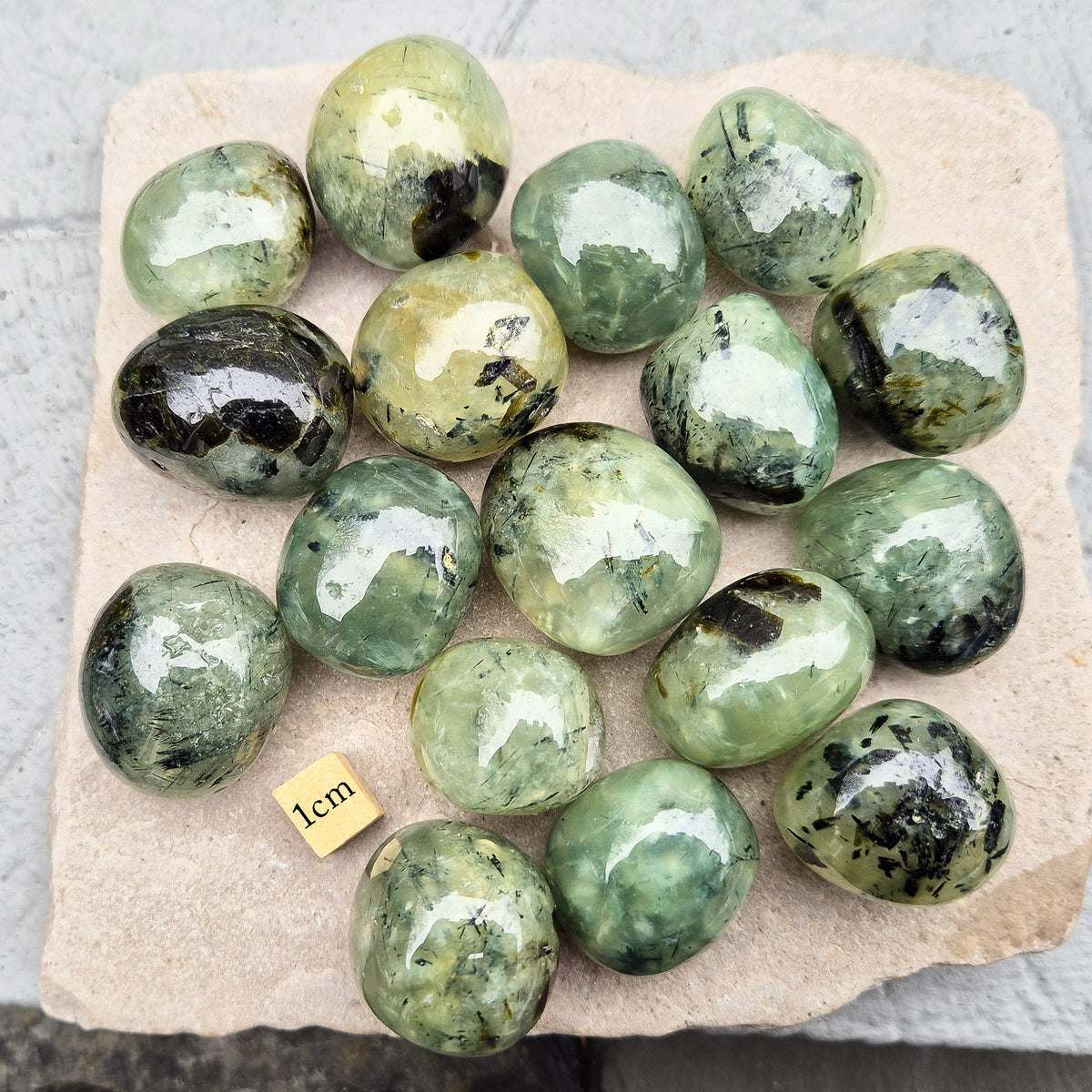 Prehnite with Epidote XL tumblestone from Mali. Natural green crystal with dark inclusions, supporting balance, growth, and steady, grounded energy. 