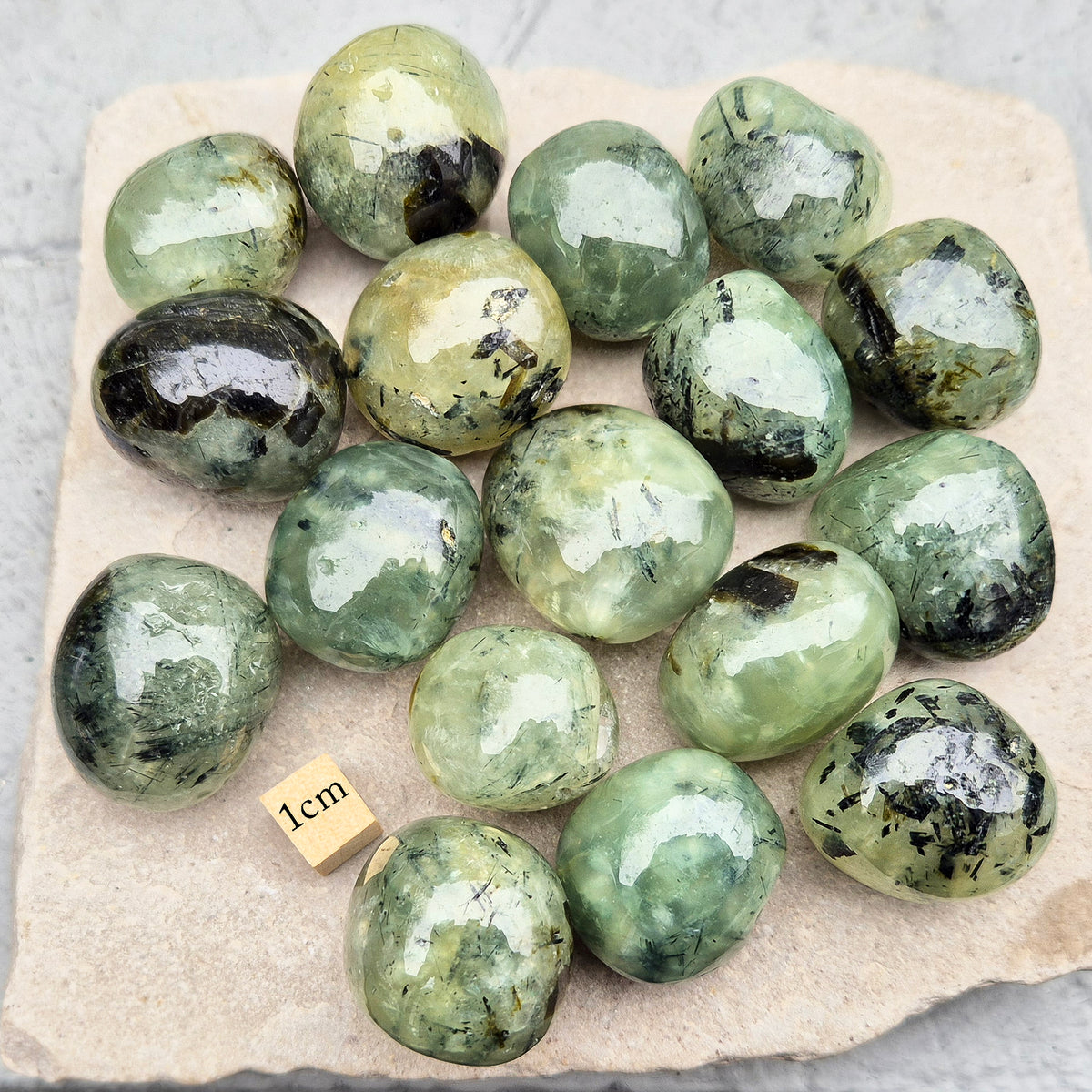 Prehnite with Epidote XL tumblestone from Mali. Natural green crystal with dark inclusions, supporting balance, growth, and steady, grounded energy. 