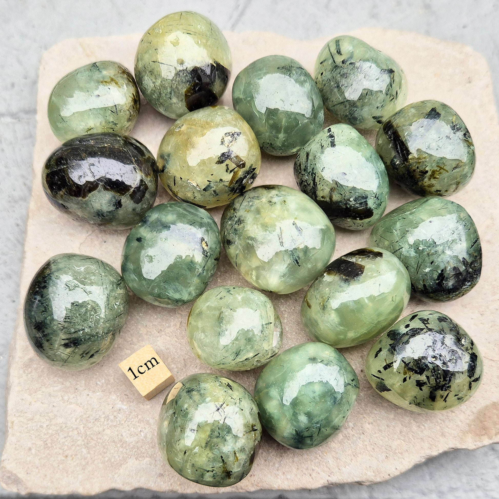 Prehnite with Epidote XL tumblestone from Mali. Natural green crystal with dark inclusions, supporting balance, growth, and steady, grounded energy. 