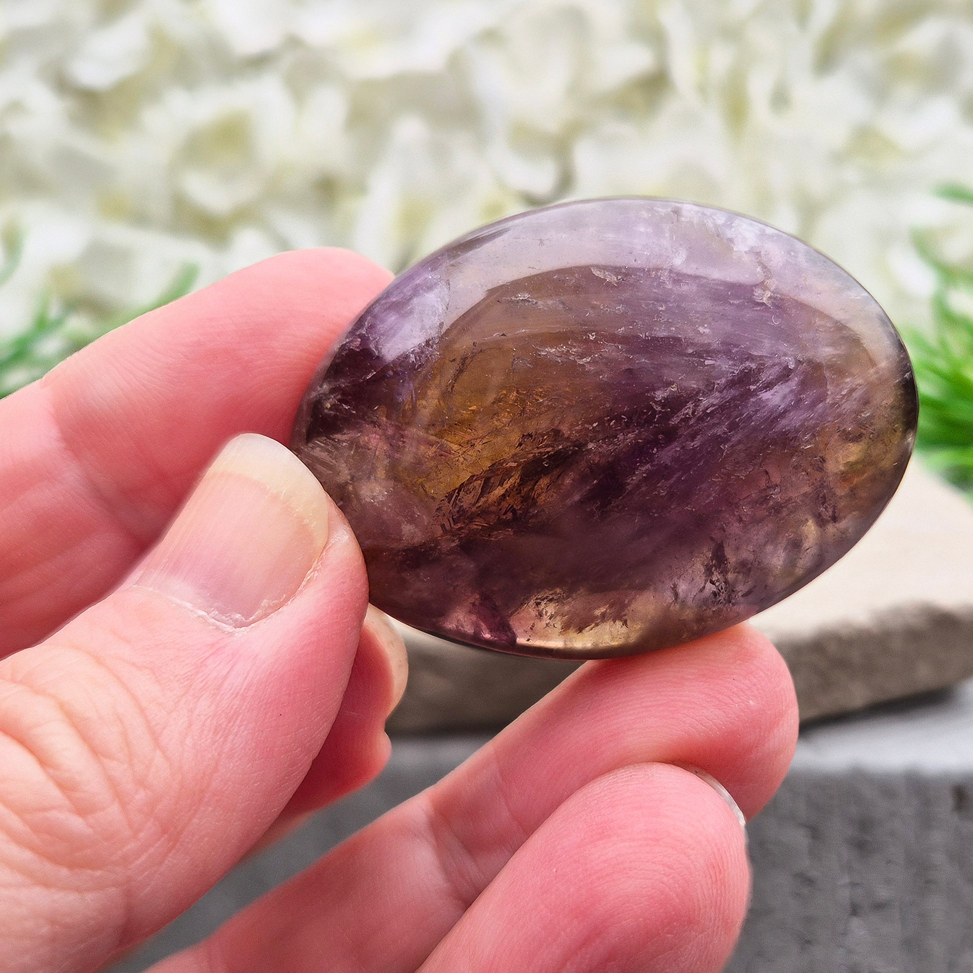Natural Ametrine palm stone with subtle colour mix and organic inclusions. A smooth, easy-to-hold crystal for focus, balance, and direction.