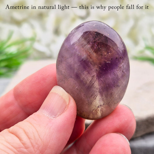 Ametrine polished palm stone with soft purple and golden tones. A natural blend of Amethyst and Citrine with a balanced, easy feel.