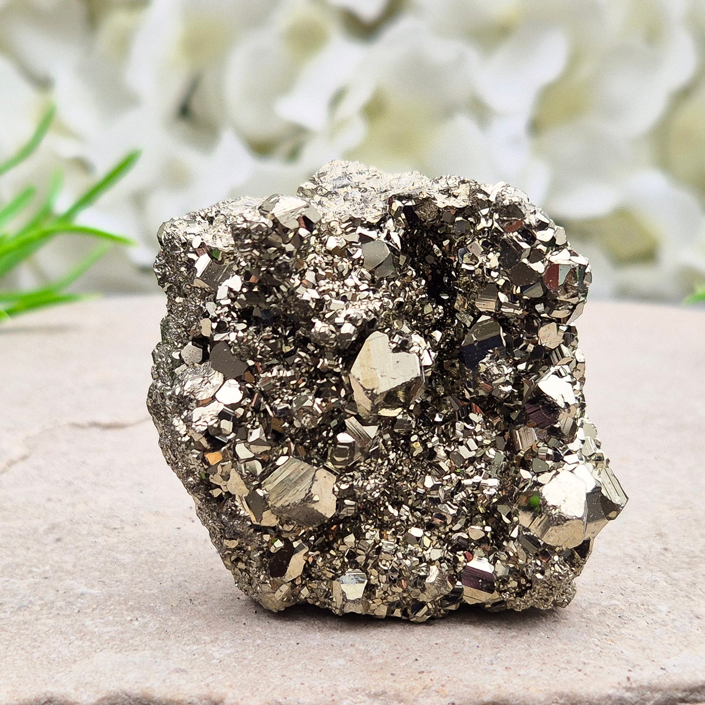 Natural pyrite crystal cluster from Peru featuring defined cubes and rich gold lustre. A striking, light-catching piece for home decor, desks, or crystal lovers.