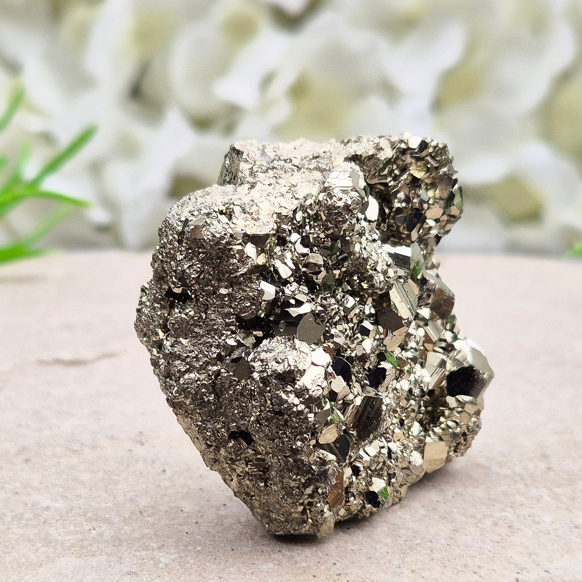 Natural pyrite crystal cluster from Peru featuring defined cubes and rich gold lustre. A striking, light-catching piece for home decor, desks, or crystal lovers.