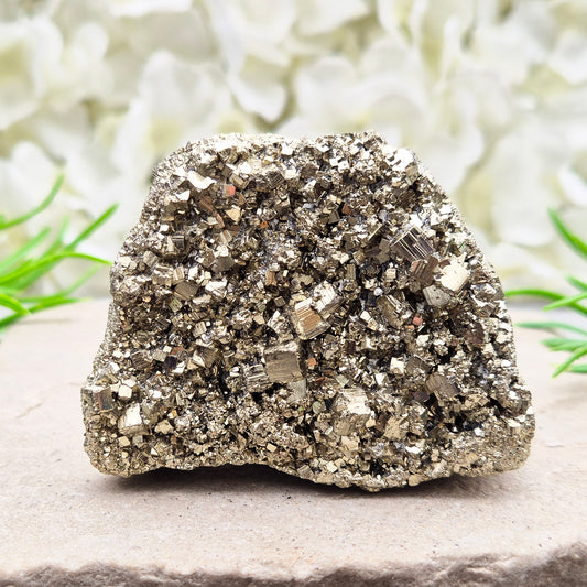 Peruvian pyrite cluster with natural cubic crystals and bright metallic shine. Sparkling druzy texture, ideal for display, grounding energy, or crystal collections.