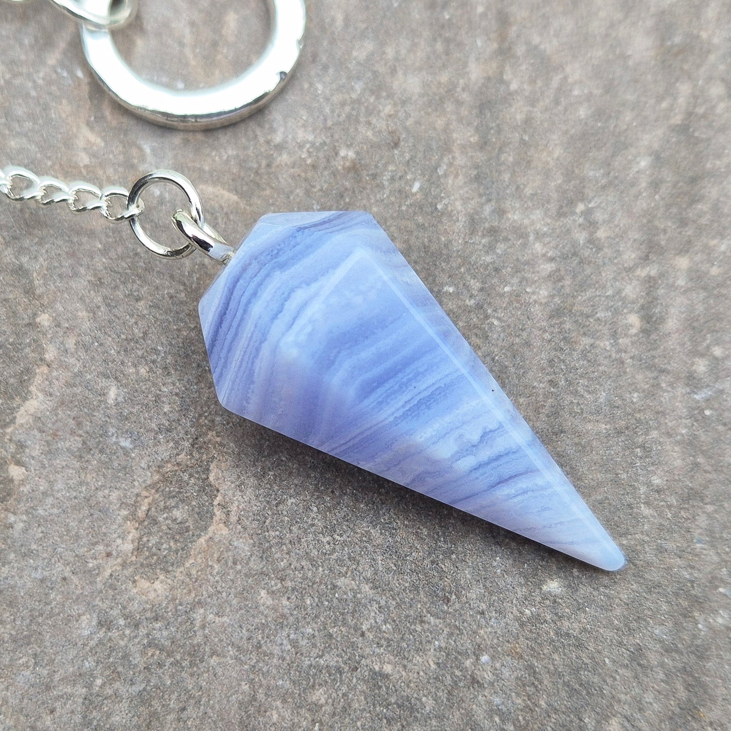 Blue Lace Agate crystal pendulum, known for its calming energy. Ideal for dowsing, spiritual guidance, and bringing a steady, peaceful feel.