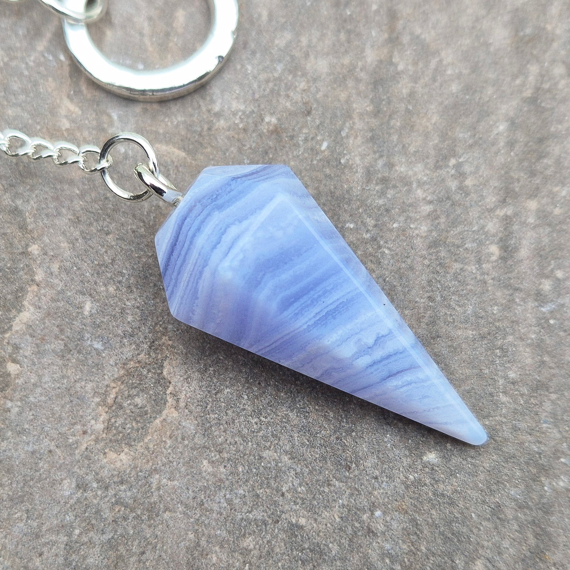 Blue Lace Agate crystal pendulum, known for its calming energy. Ideal for dowsing, spiritual guidance, and bringing a steady, peaceful feel.