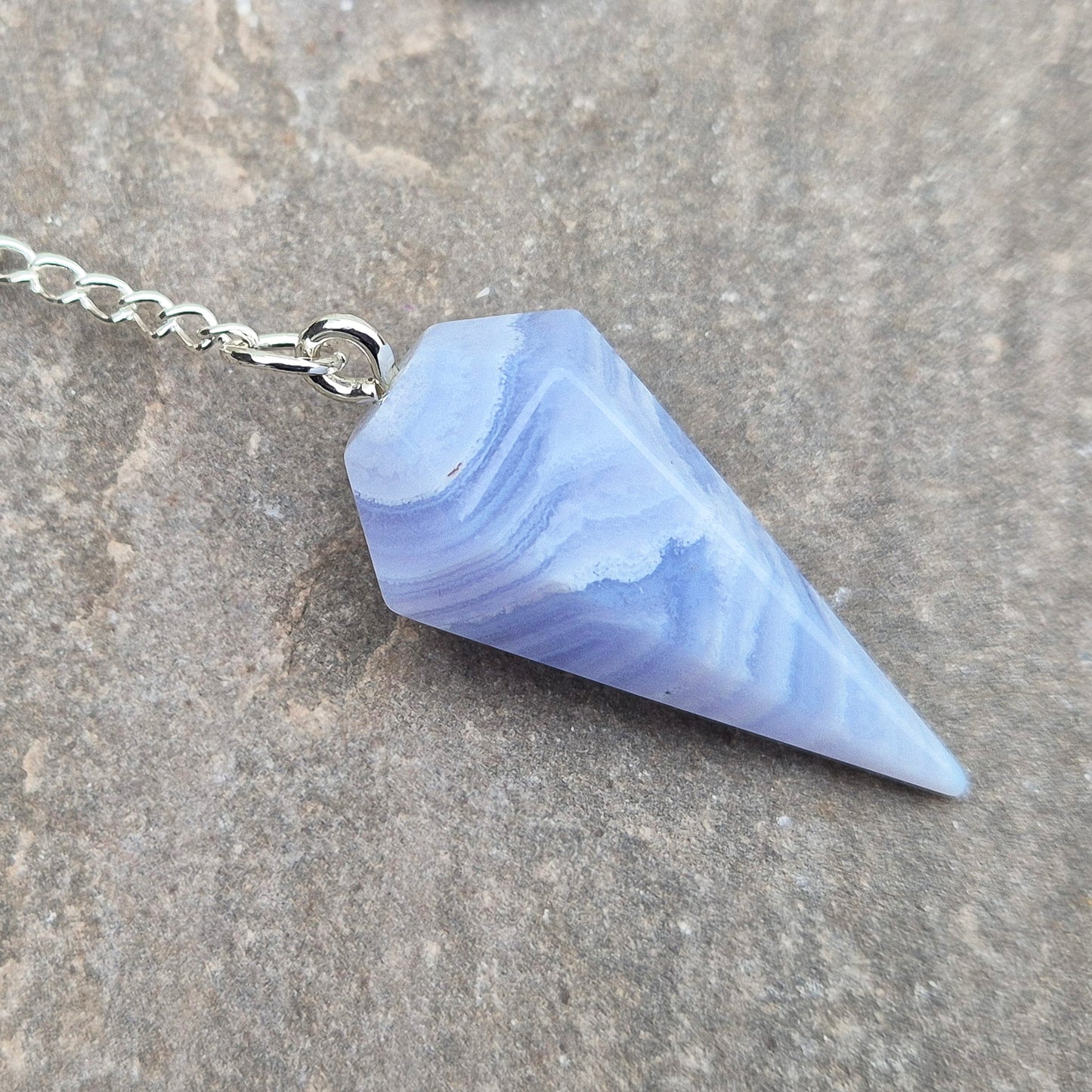 Blue Lace Agate crystal pendulum, known for its calming energy. Ideal for dowsing, spiritual guidance, and bringing a steady, peaceful feel.