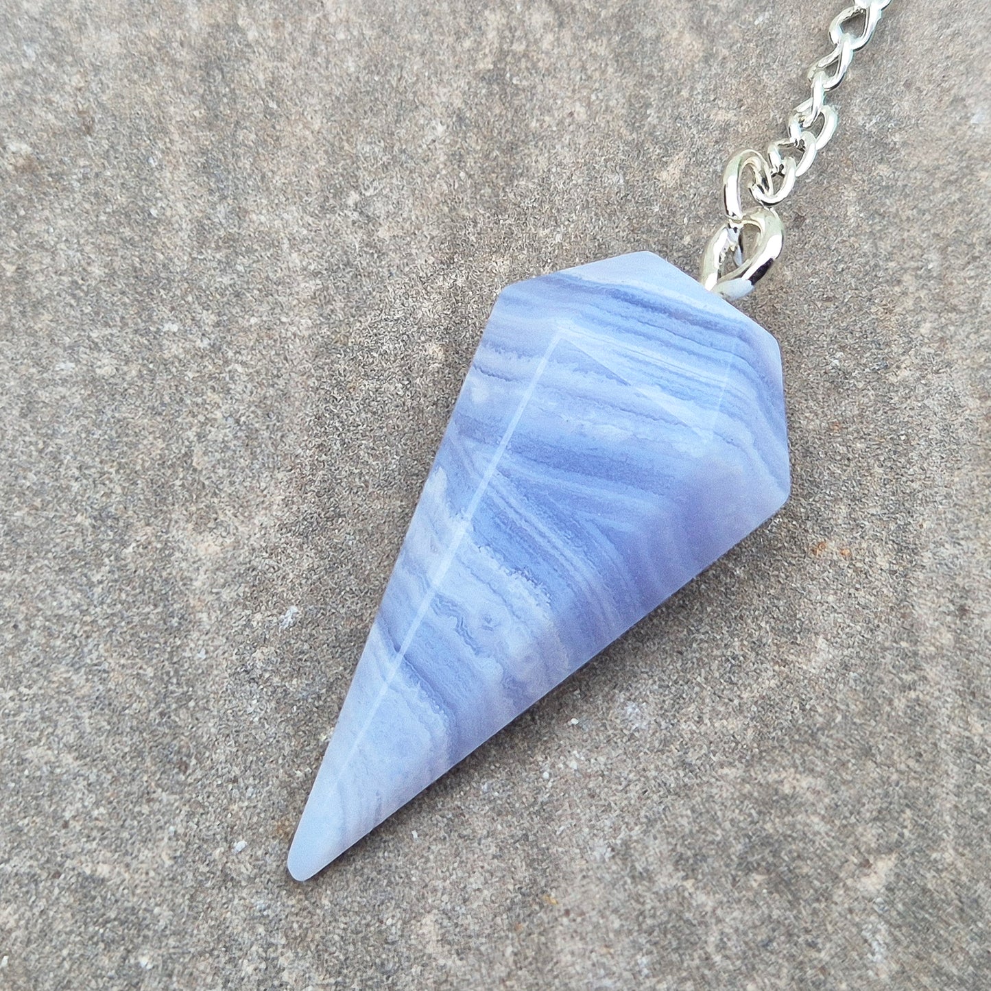 Blue Lace Agate crystal pendulum, known for its calming energy. Ideal for dowsing, spiritual guidance, and bringing a steady, peaceful feel.