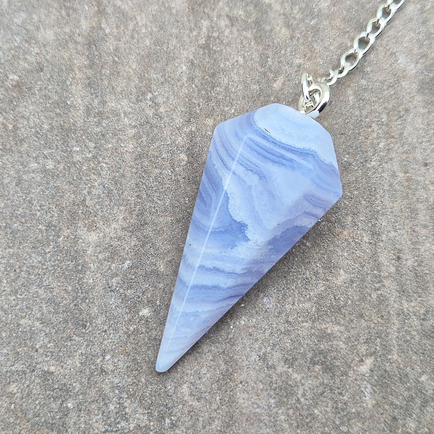 Blue Lace Agate crystal pendulum, known for its calming energy. Ideal for dowsing, spiritual guidance, and bringing a steady, peaceful feel.