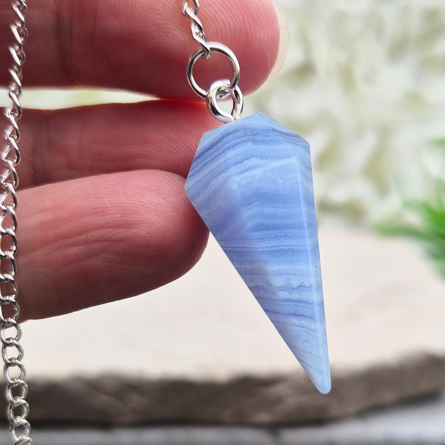 Blue Lace Agate crystal pendulum, known for its calming energy. Ideal for dowsing, spiritual guidance, and bringing a steady, peaceful feel.