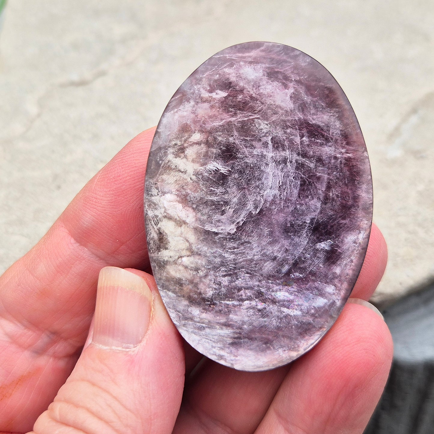 Metallic lilac Mica palm stone. Smooth, reflective, and grounding. Supports focus, calm emotions, and adds uplifting energy to any space.