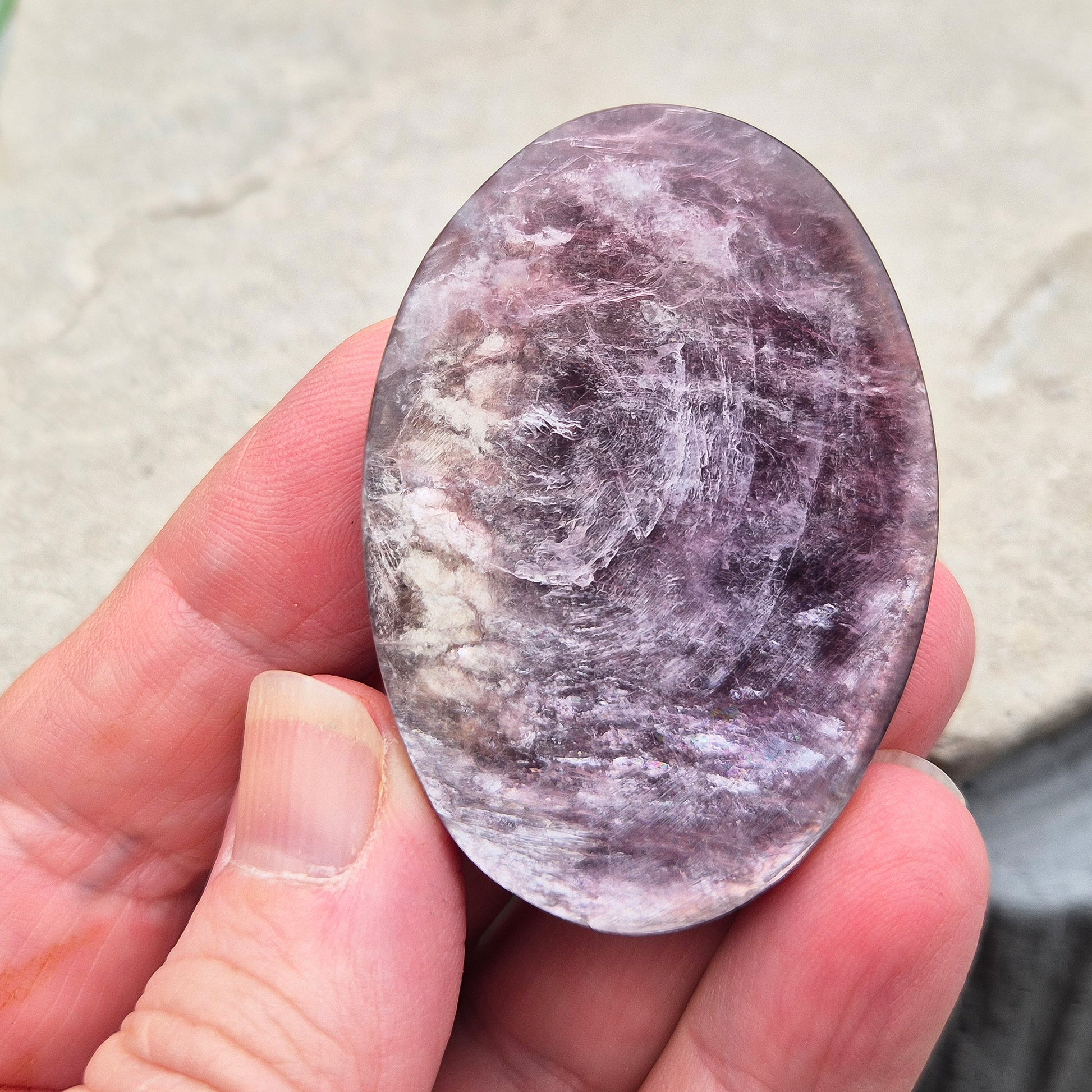 Metallic lilac Mica palm stone. Smooth, reflective, and grounding. Supports focus, calm emotions, and adds uplifting energy to any space.