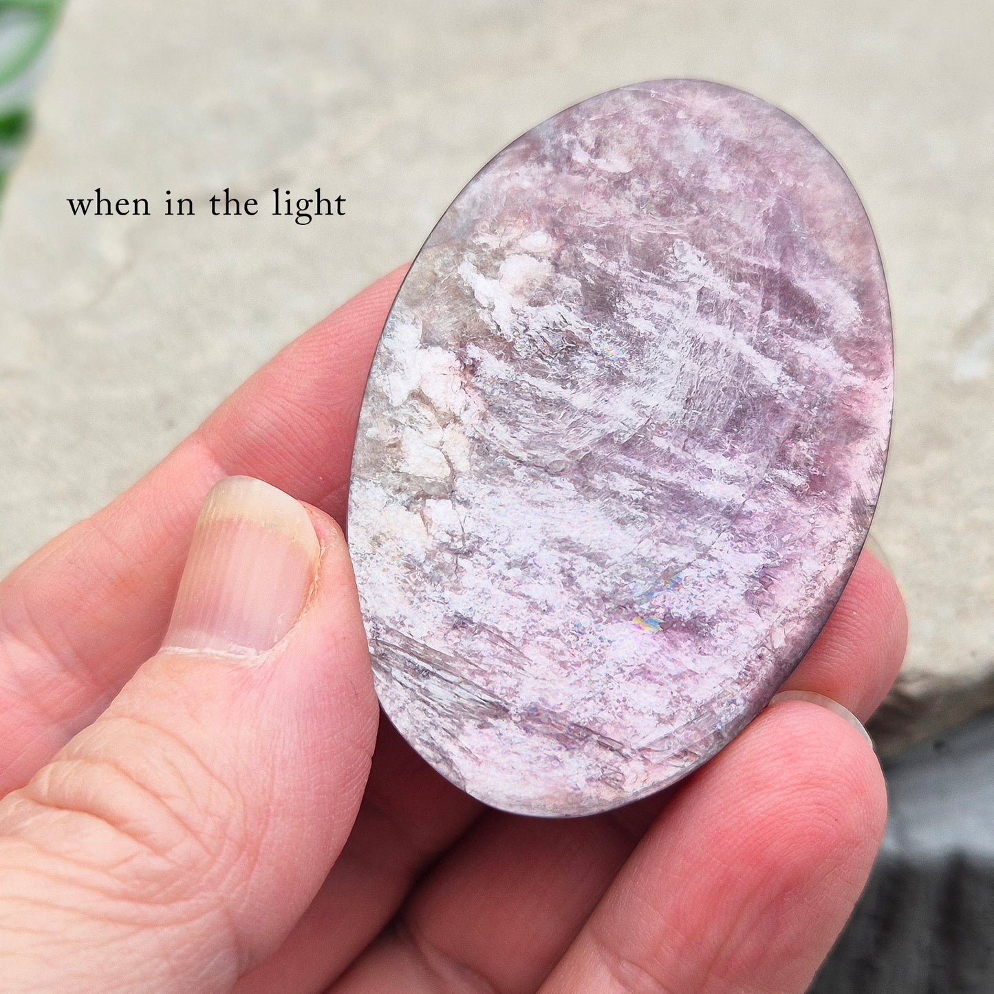 Metallic lilac Mica palm stone. Smooth, reflective, and grounding. Supports focus, calm emotions, and adds uplifting energy to any space.