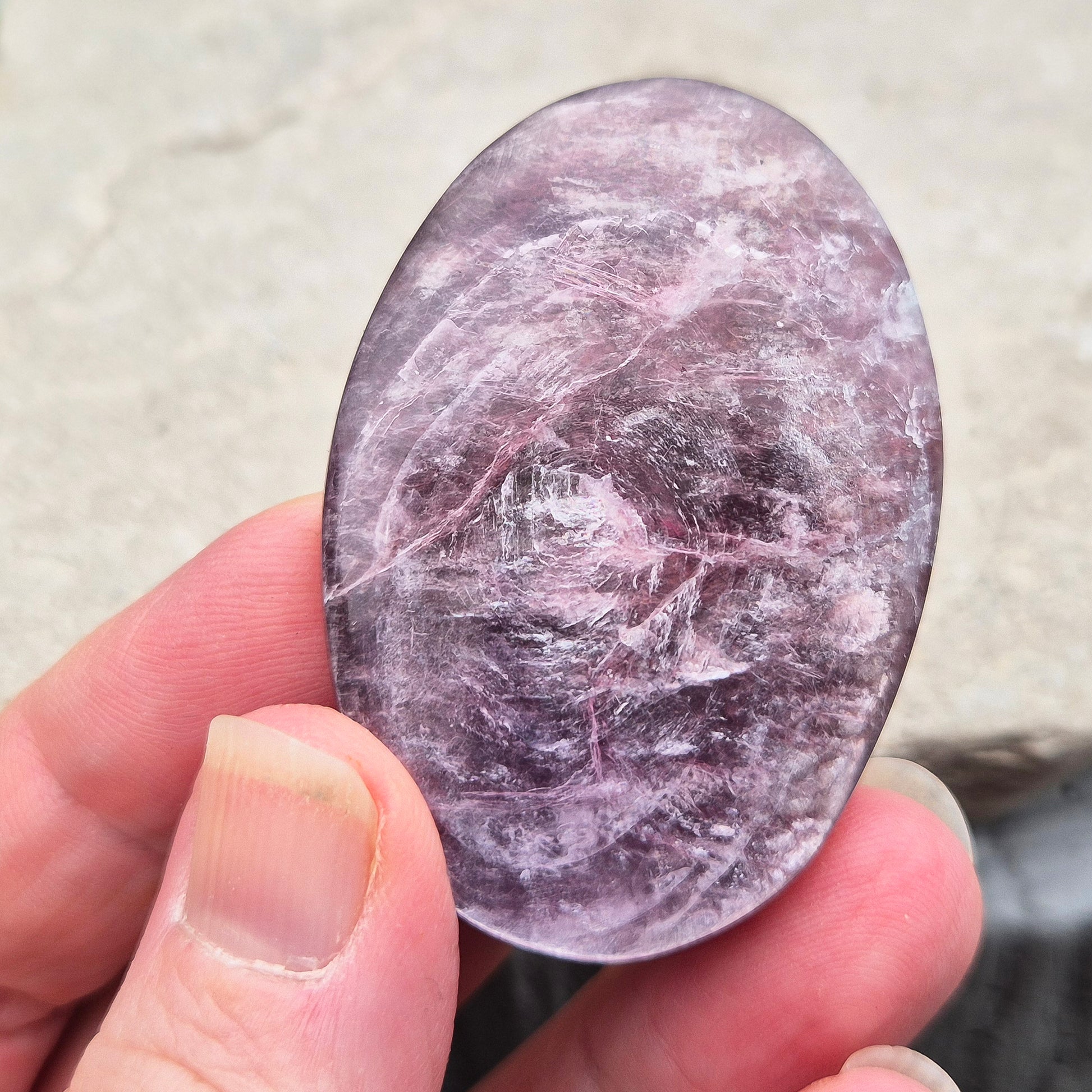 Metallic lilac Mica palm stone. Smooth, reflective, and grounding. Supports focus, calm emotions, and adds uplifting energy to any space.