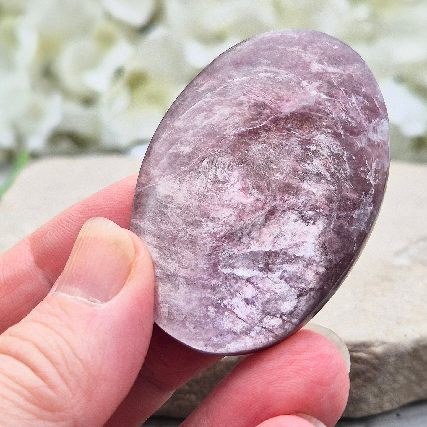 Metallic lilac Mica palm stone. Smooth, reflective, and grounding. Supports focus, calm emotions, and adds uplifting energy to any space.