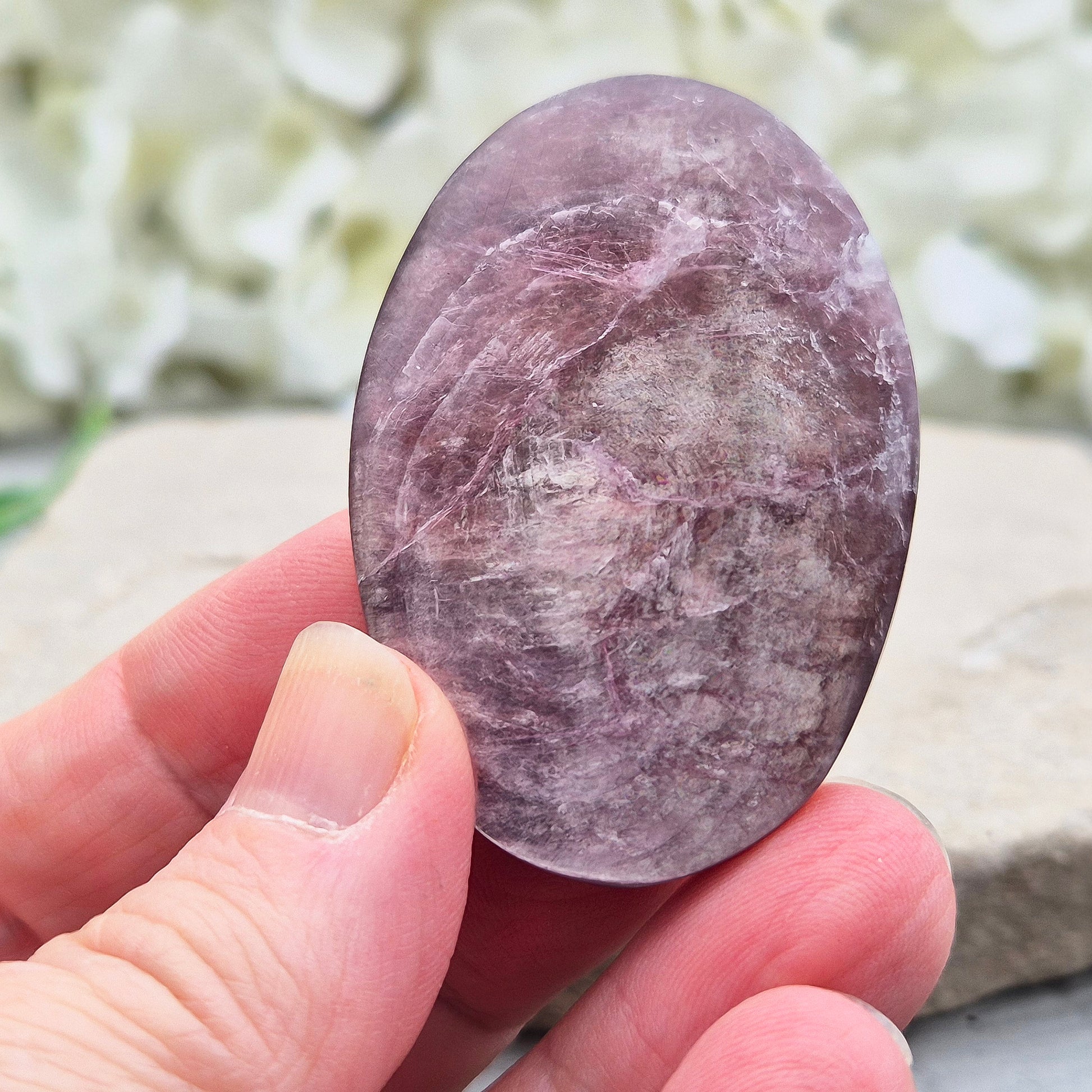 Metallic lilac Mica palm stone. Smooth, reflective, and grounding. Supports focus, calm emotions, and adds uplifting energy to any space.