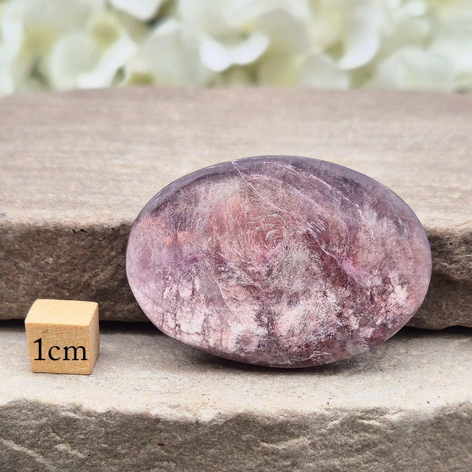 Metallic lilac Mica palm stone. Smooth, reflective, and grounding. Supports focus, calm emotions, and adds uplifting energy to any space.